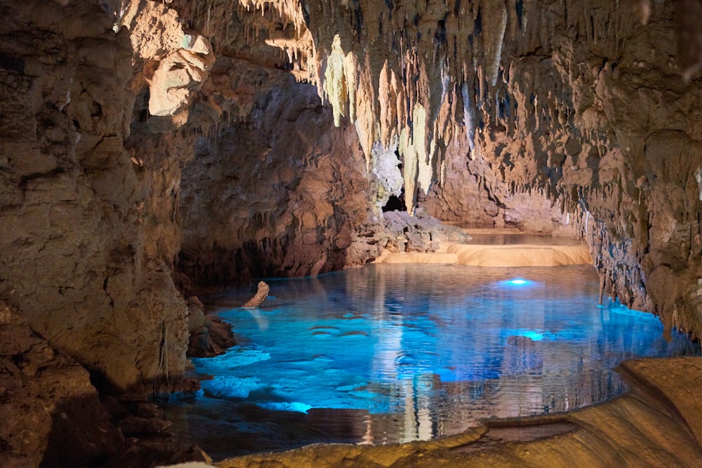 A limestone cave with calm water inside