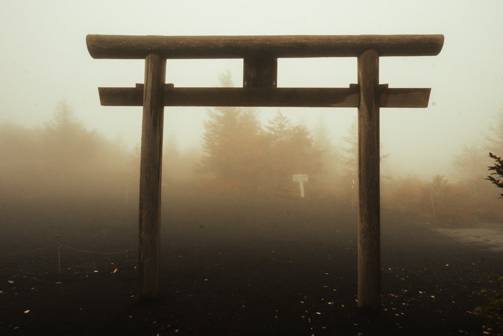 Wooden torii gate standing in a misty Japanese forest