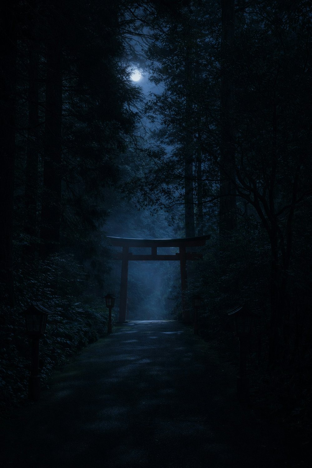 A mysterious torii gate in a foggy forest at night