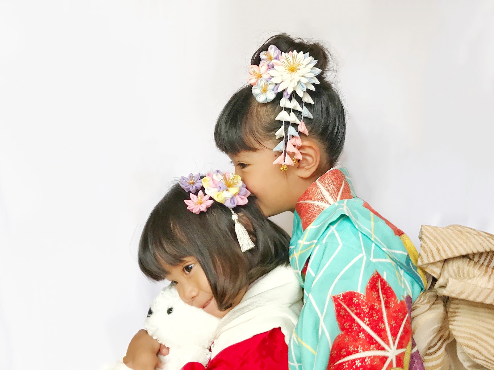 Two young girls in kimono wearing pastel tsumami kanzashi flower hair ornaments for Shichi-Go-San