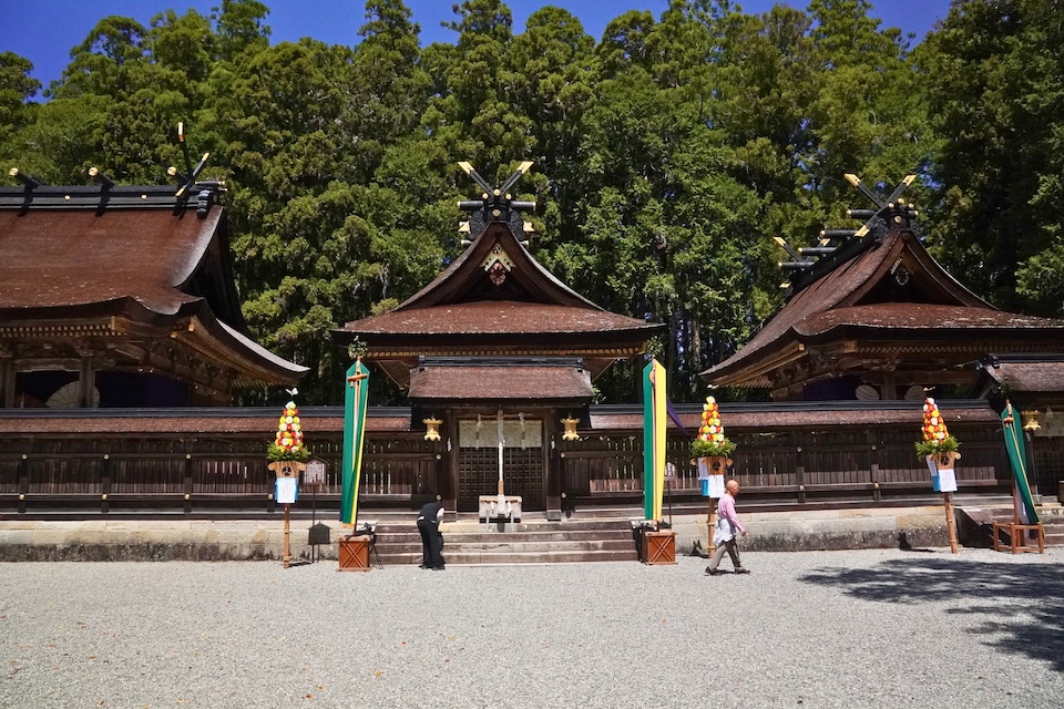 The cypress-bark halls of Kumano Hongu Taisha across a white gravel courtyard