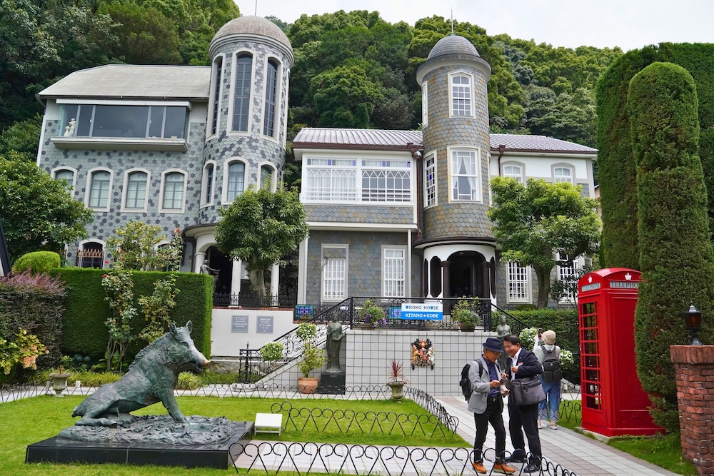 A historic Western-style house with towers and a wild boar statue in Kitano Ijinkan-gai, Kobe